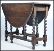 A 1920's solid oak barley twist gateleg dining tab