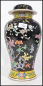 A large early to mid 20th century Chinese lidded ceramic vase heavily decorated with birds of