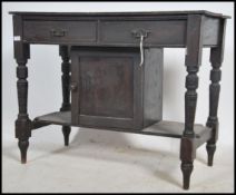 An Edwardian oak washstand with turned legs and lo