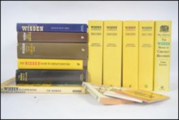 A group of hard back Wisden cricket history books