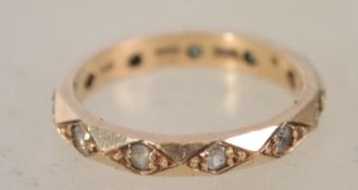 A 9ct gold and paste stone set eternity ring. The