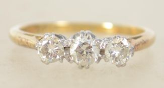A vintage ladies 18ct gold, platinum and diamond 3 stone ring. The 3 diamonds being round cut approx