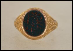 A 15ct gold marked signet ring having a central bl