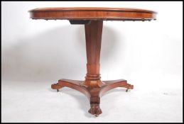 A Victorian rosewood tilt top circular breakfast t