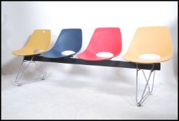 A contemporary Charles & Ray Eames style 4 seat be