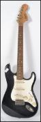 A 20th century Squier by Fender Strat guitar by Fender having two tone body with rosewood neck and 6