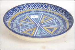 A believed 19th century Persian bowl of circular form with raised edges and circular raised foot.