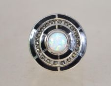 A ladies contemporary silver onyx and opal ring in
