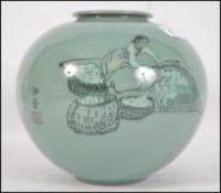 A 20th century Oriental Celadon crackle glaze vase of bulbous form depicting a maiden with character