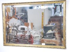 A 20th century vintage framed mirror decorated wit