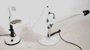 A retro white Anglepoise desk lamp raised on circu