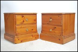 A pair of antique style pine bedside drawers each