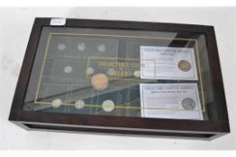 A collection of USA American coins and coinage held within a glass display case.