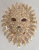 A signed Attwood and Sawyer rhinestone set gold tone figural brooch in the form of a lion with amber