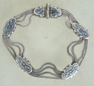 A silver 900 multi strand fox tail link bracelet chain, having niello panel spacers and pin clasp.