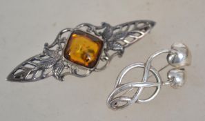 A sterling silver 925 Art Nouveau style brooch having leaf design with central amber cabochon with