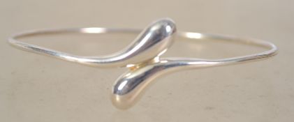 A sterling silver contemporary bangle being marked 925. Weighs 6.6 grams and measures 6.5 cms in