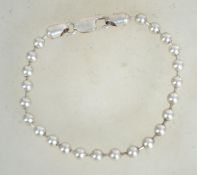 A sterling silver 925 bracelet chain having silver ball spacers and a lobster claw clasp.