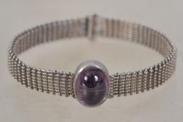 A vintage silver and amethyst woven wire bangle bracelet. Unmarked but tests as silver. Measures 6.
