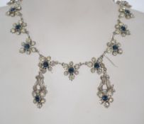 A 1950s/60s blue and white rhinestone necklace and earring set in a silver tone setting with a