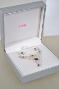 A silver and garnet stone necklace and earring set being boxed and appearing unworn. Weighs 8.2