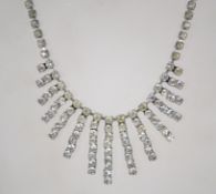 A vintage 1950s rhinestone necklace and hook earrings set in a silver tone metal setting having a