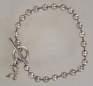 A sterling silver 925 bracelet chain having silver bead spacers and a toggle clasp. Measures 8