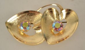 A 1960s aurora rhinestone double heart brooch gold tone setting with rollover catch. Measures 5.7