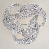 A signed Attwood and Sawyer rhinestone set silver tone brooch with roller clip clasp. Measures