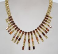 A vintage 1960s/70s rhinestone statement necklace having yellow and brown round baguette rhinestones