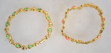 Two gold tone Joan Rivers link Bracelets set with green and coral stones . Measures approx 7