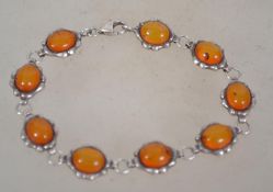 A sterling sliver 925 bracelet chain having amber cabochons with silver bone borders. Weighs 11.6