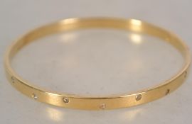 A Swarovski gold plated bangle bracelet set with crystals bearing the swan mark to inside.