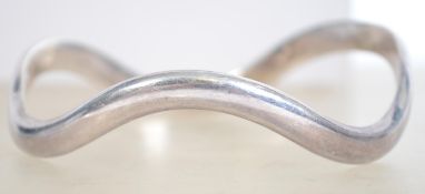 A sterling silver 925 bangle bracelet of wave form. Measures 7 cm wide and weighs 34.2 grams.