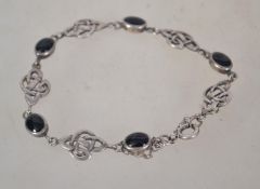 A sterling silver 925 bracelet chain having a Celtic knot design and onyx cabochon spacers having