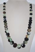 An unstrung set of large graduated banded agate faceted beads. Largest 2cms smallest 1cms.