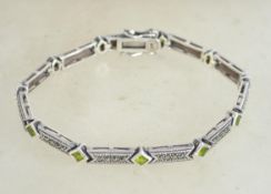 A sterling silver 925 and marcasite bracelet chain having peridot stone spacers and marcasite