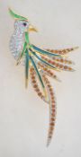 A  signed gold tone rhinestone set figural brooch in the form of a bird of paradise with roller clip
