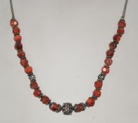 A vintage silver and carnelian bead necklace having a bolt ring clasp. Unmarked tests as silver
