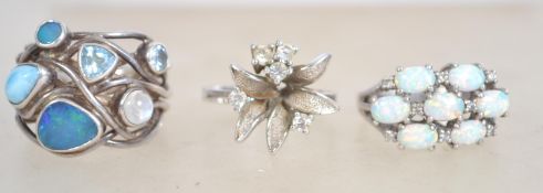 A group of three sterling silver 925 dress rings, one of floral form with clear stones, one of rigid