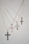 A group of 4 sterling silver 925 necklace chains each having a crucifix drop pendant of varying