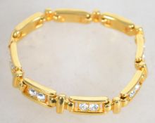A gold tone Joan Rivers link bracelets set with clear rhinestones . Measures approx 7inches.