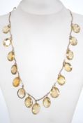 A fantastic rigid link necklace chain in a gold tone setting, having many faceted citrine coloured