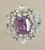 A sterling silver 925 ladies dress ring having central faceted pink stone adorned with a halo of