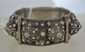 A large vintage heavy coin silver hinged bangle with rope work and pin fastening.  Partial makers