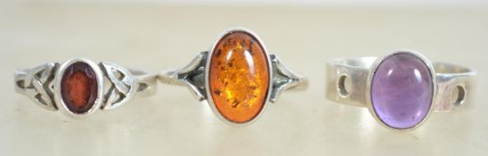 A group of sterling silver 925 dress rings, one set with purple amethyst, one set with amber