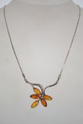 A sterling silver 925 snake link necklace chain with lobster claw clasp, having an amber leaf