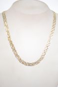 A sterling silver and bonded gold fancy link necklace chain of Celtic knot wave form, having a