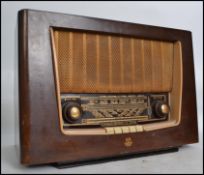 A vintage mid 20th century Regentone walnut cased valve radio having dials to front. Measures: