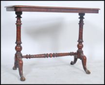 A Victorian mahogany writing table / side hall table being raised on spiral twist supports having
